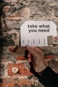 A paper reads, "take what you need." This reflects concepts discussed in counseling in Lakewood, CO with Hot Mess Counseling.