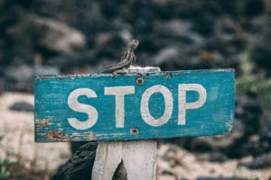 A sign reads "stop." This reflects concepts discussed in blog post by online therapist in Denver, CO with Hot Mess Counseling about the benefits of starting online therapy in Denver, CO.