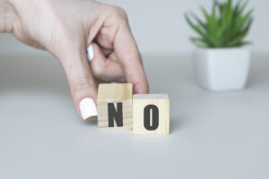 Wooden blocks read "no." This reflects concepts in this blog discussed for stressed out moms in Denver, CO who need counseling for moms in Denver, CO with Hot Mess Counseling. You can get online therapy in Denver and online counseling in Colorado here.